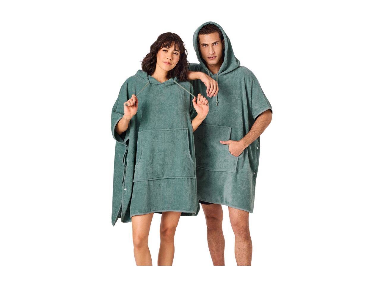 Two people wearing matching green hooded poncho towels.