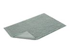 A sage green bath mat with a textured surface is shown folded slightly.