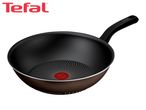 A dark brown wok with a black handle and a red heat indicator in the center of the cooking surface.