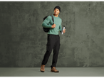 Man in CRIVIT thermal sports trousers, green long-sleeve shirt, and beanie, holding a water bottle.