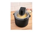 Ice cream maker with yellow ice cream, with a bowl of scoops in the background.