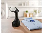 SilverCrest handheld garment steamer and a folded blue shirt on a wooden table.