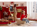 Two children playing in a room with a Lupilu Kids' Wooden Easel and other toys.