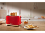 Red toaster with toasted bread and jam on a wooden table.