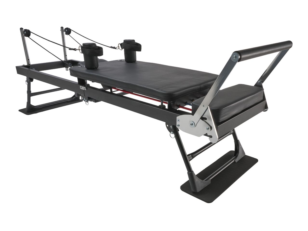 Black Pilates reformer machine with padded carriage, ropes, and foot bar.