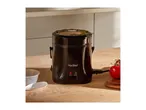 A black VonShef rice cooker on a wooden table with a tomato and measuring cup.