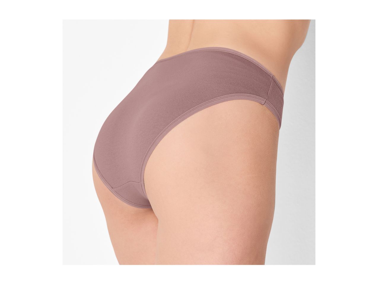 Woman wearing light brown high-waisted briefs, side view