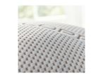 Close-up of a mattress with a textured surface and subtle branding.