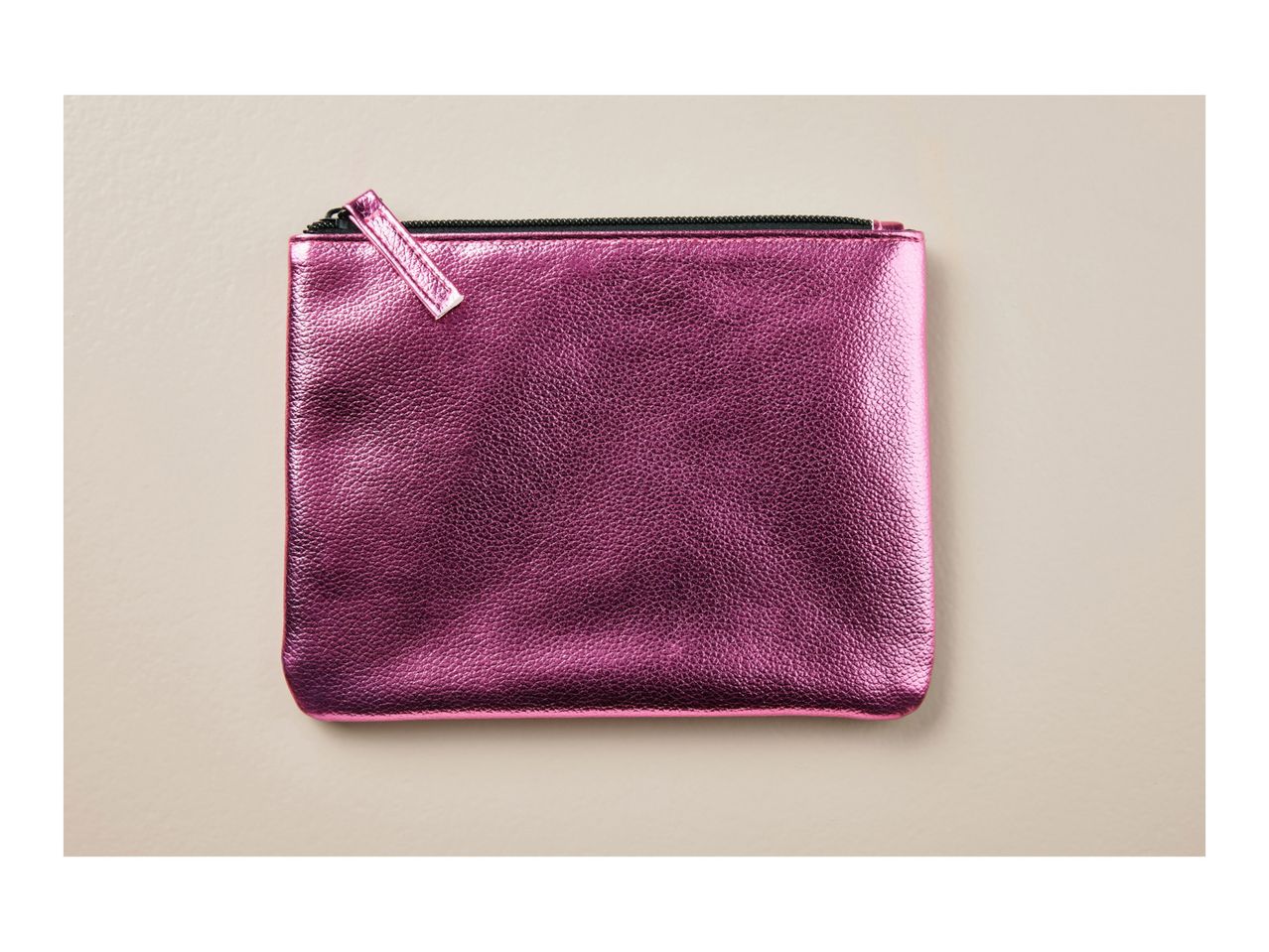 A metallic pink zipper pouch.