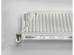 A white radiator with a smart thermostat and a fan booster attached to its bottom.