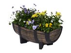 Barrel planter with purple pansies and yellow chrysanthemums.
