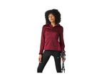 Woman in a maroon hooded jacket and black leggings, holding hiking poles.