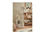 A fluffy brown cat playing on a multi-level cat tree with scratching posts and a hanging toy.