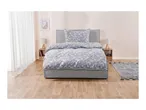 Bedroom with a grey upholstered bed, patterned duvet, and wooden nightstands.