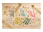 Colorful plastic cutlery sets with confetti and streamers on a wooden table.