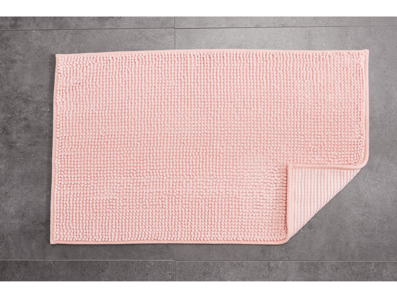 LIVARNO home pink bath mat on a gray tiled floor
