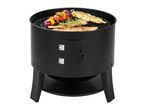 Black charcoal barbecue with grilled meat, chicken skewers, and vegetable skewers.