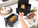 Salter VertiCook Air Fryer 10L cooking salmon, with fries and fried chicken nearby.