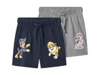 To par shorts til børn, et mørkeblåt med Chase og Rubble, og et gråt med Paw Patrol-figurer.