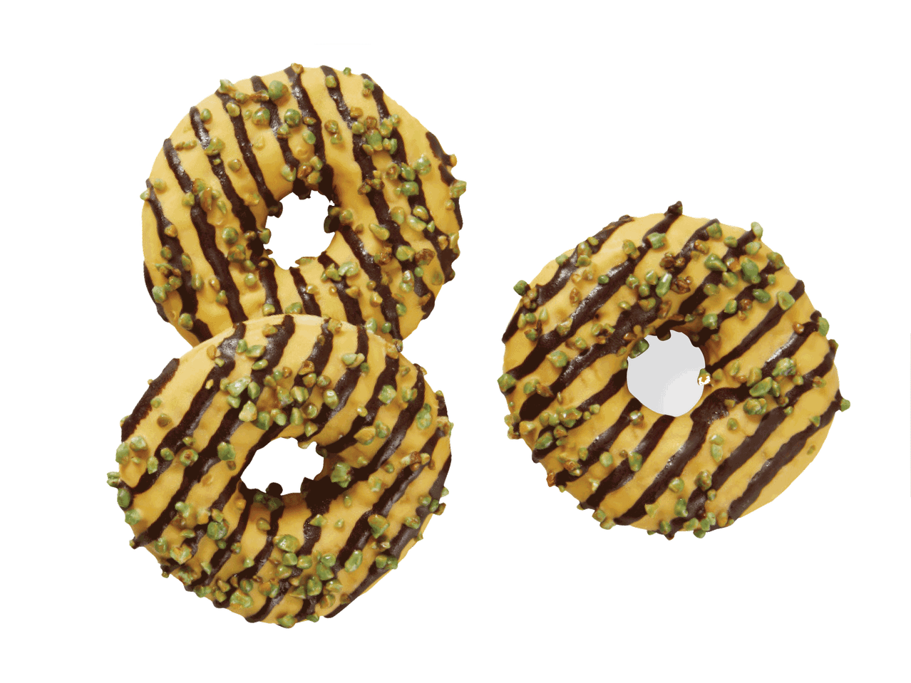 Trys spurgos su geltonu glajumi, šokolado juostelėmis ir žaliais pabarstukais.