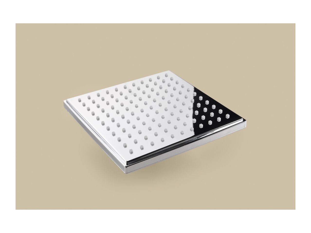 A square, chrome-plated shower head with numerous white nozzles, angled on a beige background.