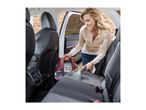 Woman cleaning car seats with a Vax spot cleaner.