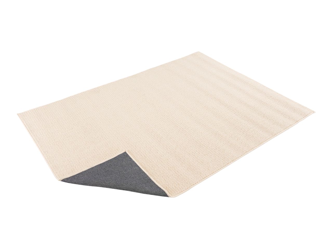 Cream-colored rectangular bath mat with a dark gray non-slip backing visible at one corner.