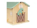 Wooden toy barn with a light green roof and painted animals