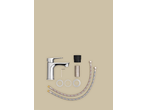 Chrome faucet with installation parts, including hoses and washers, on a beige background.