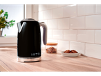 Black Silvercrest® kettle on a kitchen counter with cookies and sugar.