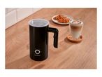 Black milk frother with a latte macchiato and croissants on a wooden surface.