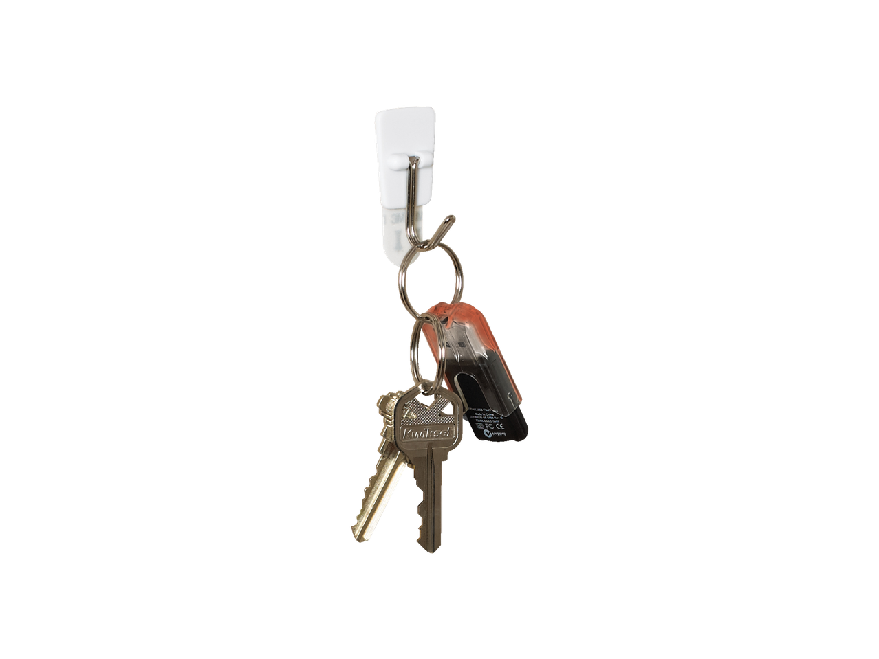 Kwikset keys hanging on an adhesive hook.