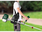 Man with a PARKSIDE petrol brush cutter, ready for grass trimming.