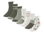 Set dječjih čarapa s uzorkom dinosaura i prugama u zelenim i bijelim nijansama.