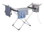 Heated clothes airer with various garments drying on it, including striped and plain shirts.