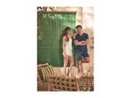 Couple in lemon-print sleepwear, woman in white camisole and shorts, man in navy t-shirt and shorts.