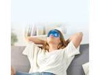 Woman relaxing on a couch with a cooling eye mask.