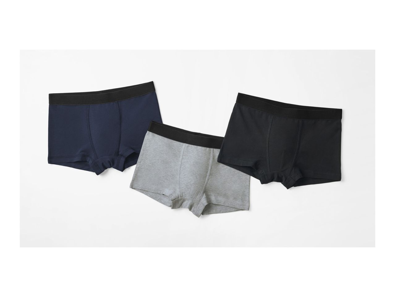 Three pairs of men's boxer briefs in navy, black, and gray.