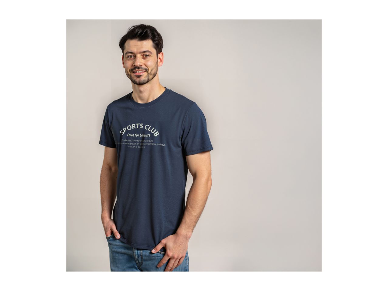 Man in a navy blue t-shirt with 'SPORTS CLUB Love for Leisure' text, and blue jeans.
