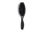 Black hairbrush with a textured handle and flexible bristles, angled to the left.