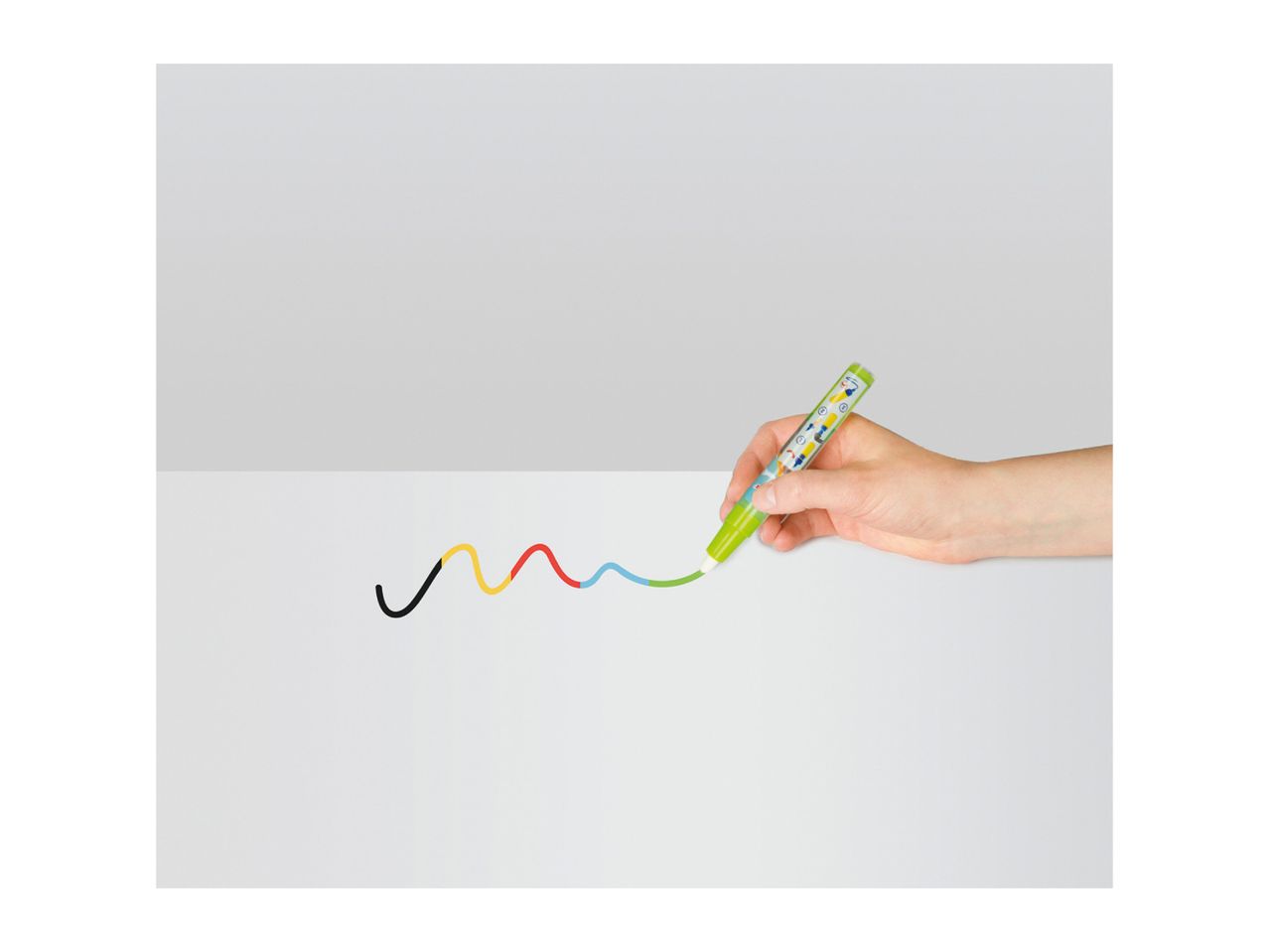 Hand drawing a colorful wavy line with a green marker on a white surface.