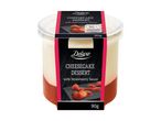 Cheesecake dessert with strawberry sauce in a clear plastic pot, 90g, with nutritional information.