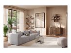 Modern living room with a grey sofa, wooden sideboard, and minimalist decor.