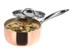 Copper saucepan with a lid, filled with creamy soup and vegetables.