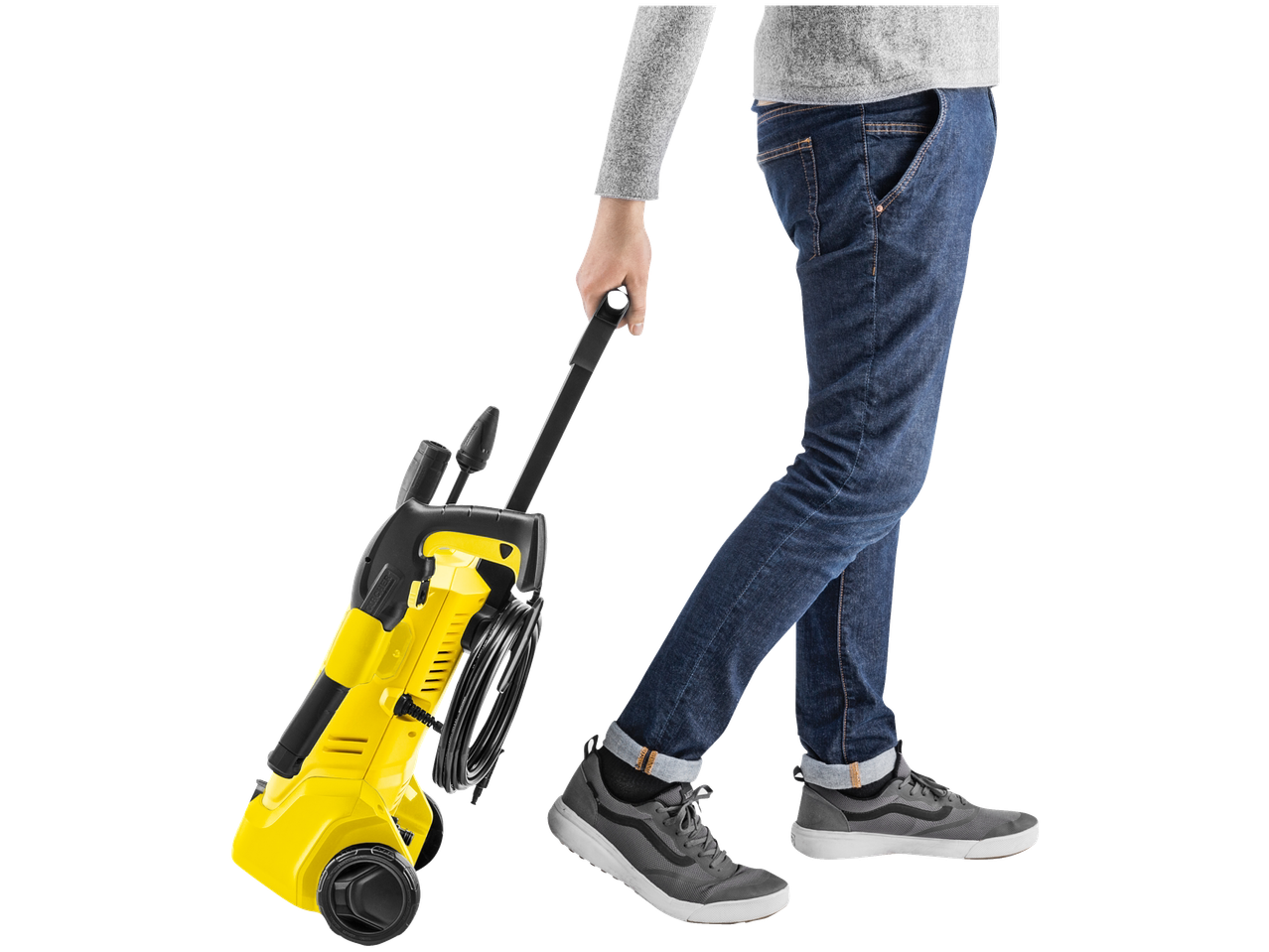 Person pulling a yellow Kärcher 1600W Pressure Washer with wheels.