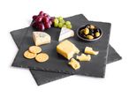 Cheese board with various cheeses, grapes, olives, and crackers on a white background.