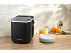 SILVERCREST® Ice Maker on a wooden counter with drinks and oranges.