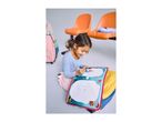 A young girl drawing on a water doodle mat, with backpacks and orange chairs in the background.