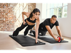 Dumbbells, ab wheel, and exercise mats in use.