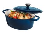 Blue oval cast iron casserole dish with lid, filled with roasted chicken and vegetables.